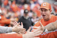 Clemson head coach Dabo Swinney high-fives fans after an NCAA college football game against South Carolina, Saturday, Nov. 30, 2019, in Columbia, S.C. Clemson won 38-3. (AP Photo/Sean Rayford)