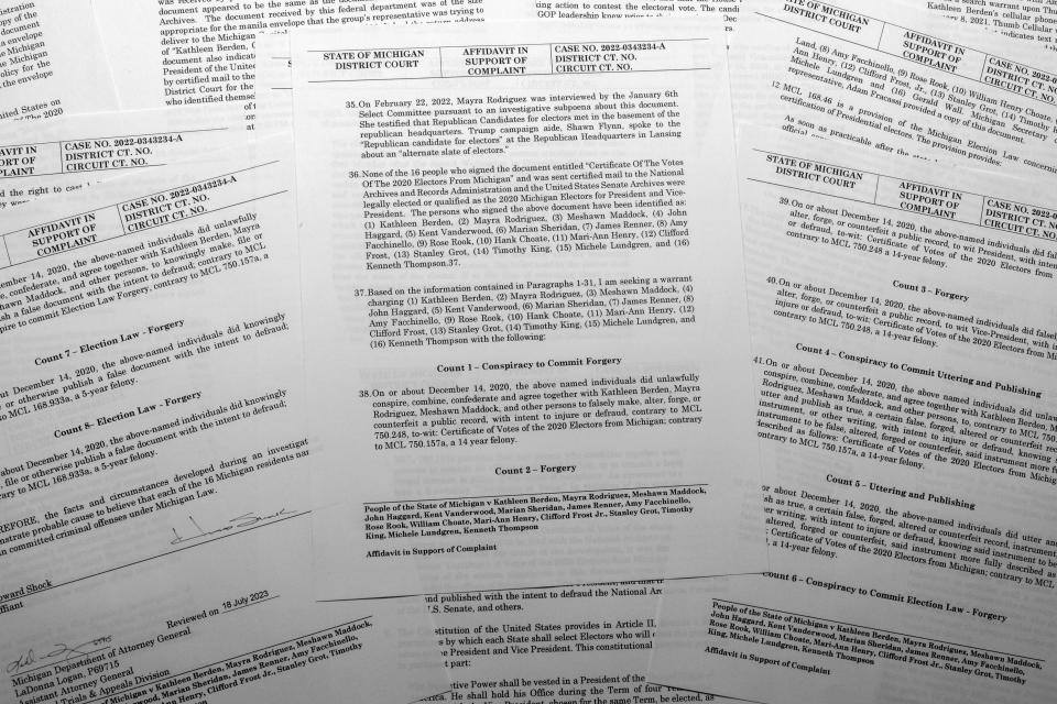 The affidavit in support of an arrest warrant for 16 fake Republican electors for Donald Trump in the 2020 presidential election in Michigan is photographed Tuesday, July 18, 2023. Michigan Attorney General Dana Nessel has charged 16 Republicans with multiple felonies after they are alleged to have submitted false certificates stating they were the state's presidential electors despite Joe Biden's 154,000-vote victory in 2020. (AP Photo/Jon Elswick)