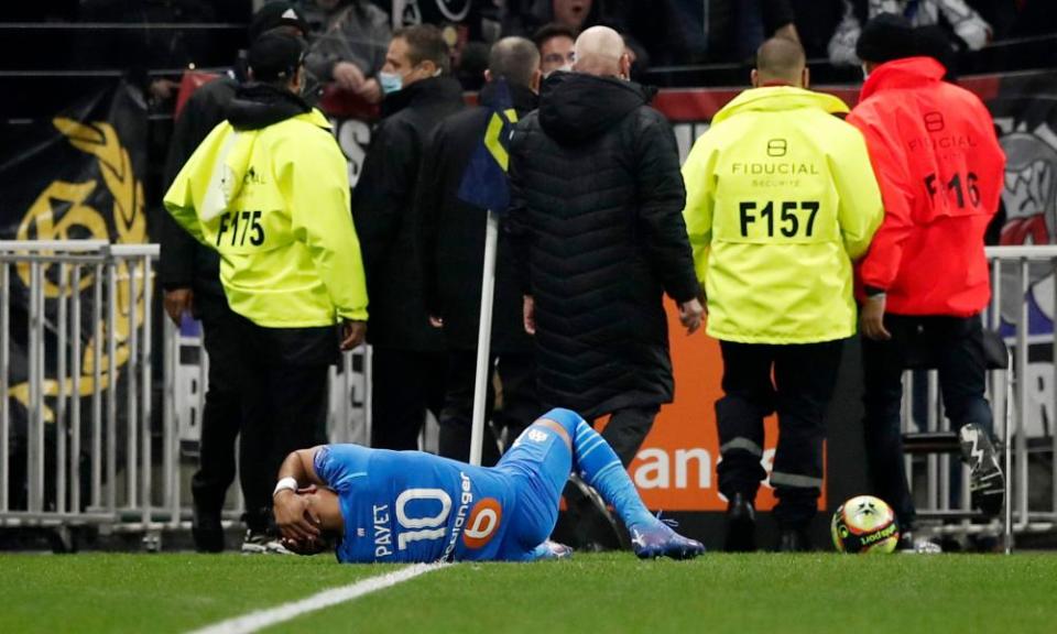 Marseille’s Dimitri Payet is struck by a water bottle thrown by a Lyon supporter.