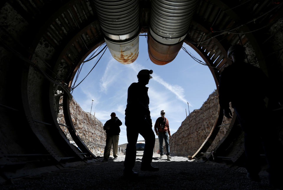 FILE - In this April 9, 2015, file photo, people walk into the south portal of Yucca Mountain during a congressional tour of the proposed radioactive waste dump near Mercury, Nev., 90 miles northwest of Las Vegas. Recent California earthquakes that rattled Las Vegas have shaken up arguments by proponents and opponents of a stalled federal plan to entomb nuclear waste beneath a long-studied former volcanic ridge in southern Nevada. The Las Vegas Review-Journal reports that Wyoming Republican Sen. John Barrasso said this week his legislation to jumpstart the process to open Yucca Mountain is based on studies that take seismic activity into account. Nevada officials disagree. (AP Photo/John Locher, File)