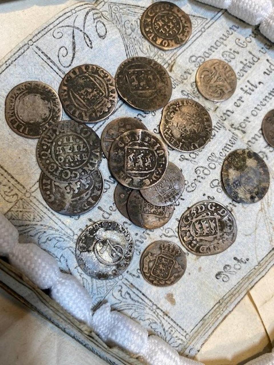 Some of the silver coins, identified as Danish skillings, in a package from 1807. Photo from The National Archives