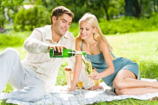 Couple having picnic with champage