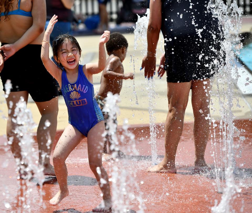 At Crompton Park Pool, Baylee Quach, 5, revels in the fountain water on Friday.