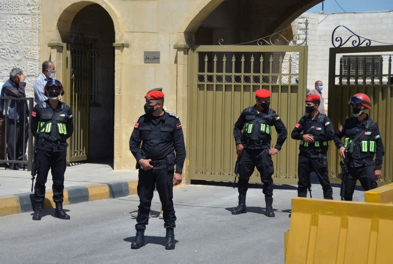 Security members stand guard outside a military court in Amman