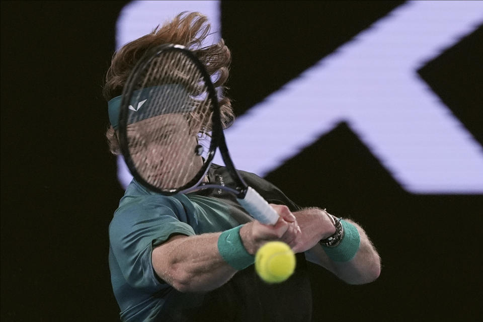 Andrey Rublev of Russia plays a forehand return to Jannik Sinner of Italy during their quarterfinal match at the Australian Open tennis championships at Melbourne Park, Melbourne, Australia, Wednesday, Jan. 24, 2024. (AP Photo/Andy Wong)