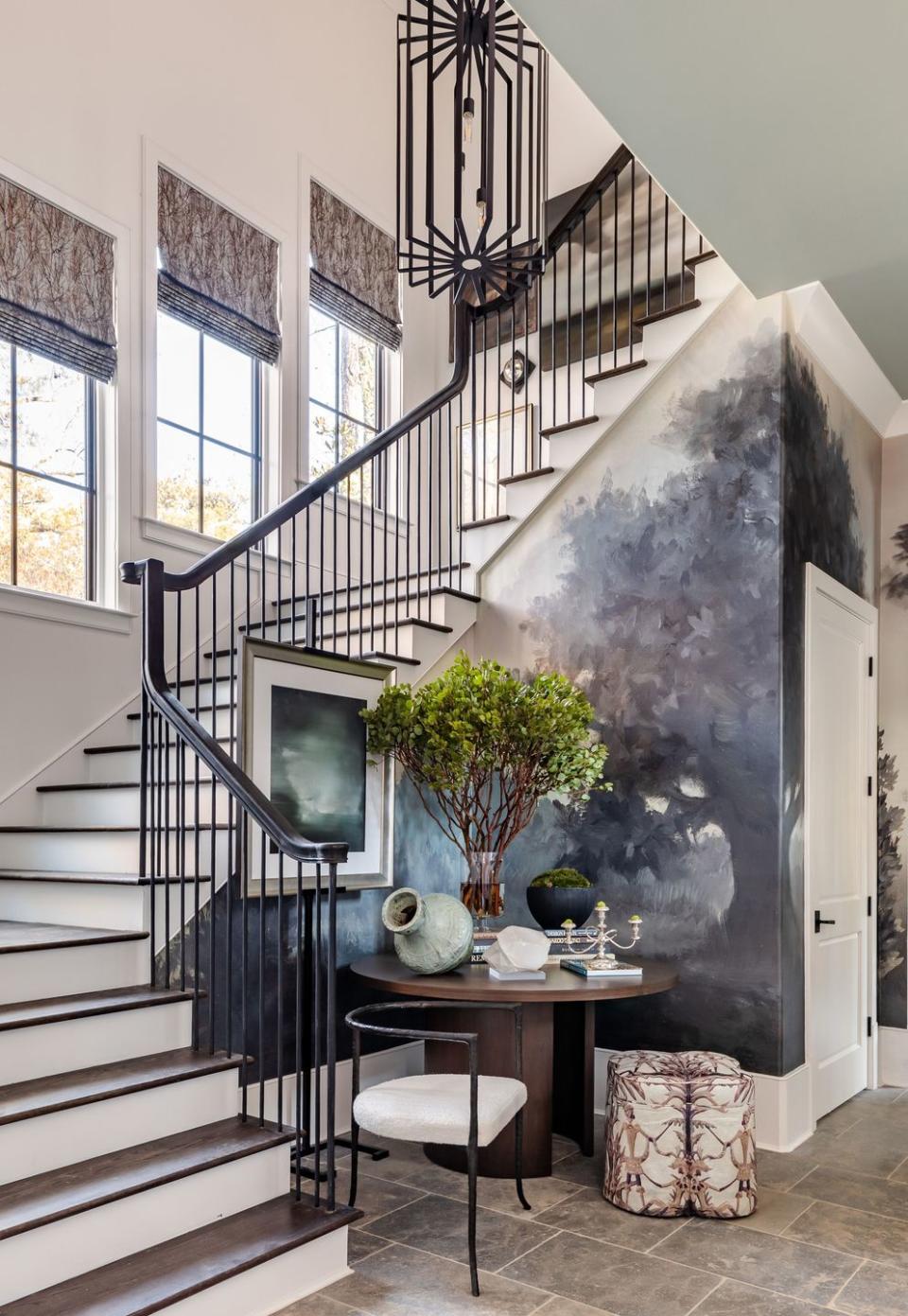 a staircase with a table and chairs