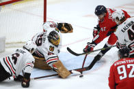 Chicago Blackhawks goaltender Marc-Andre Fleury (29), defenseman Jake McCabe (6) and defenseman Wyatt Kalynuk (48) defend against Washington Capitals defenseman Martin Fehervary (42) during the third period of an NHL hockey game Thursday, Dec. 2, 2021, in Washington. The Blackhawks won 4-3 in a shootout. (AP Photo/Nick Wass)