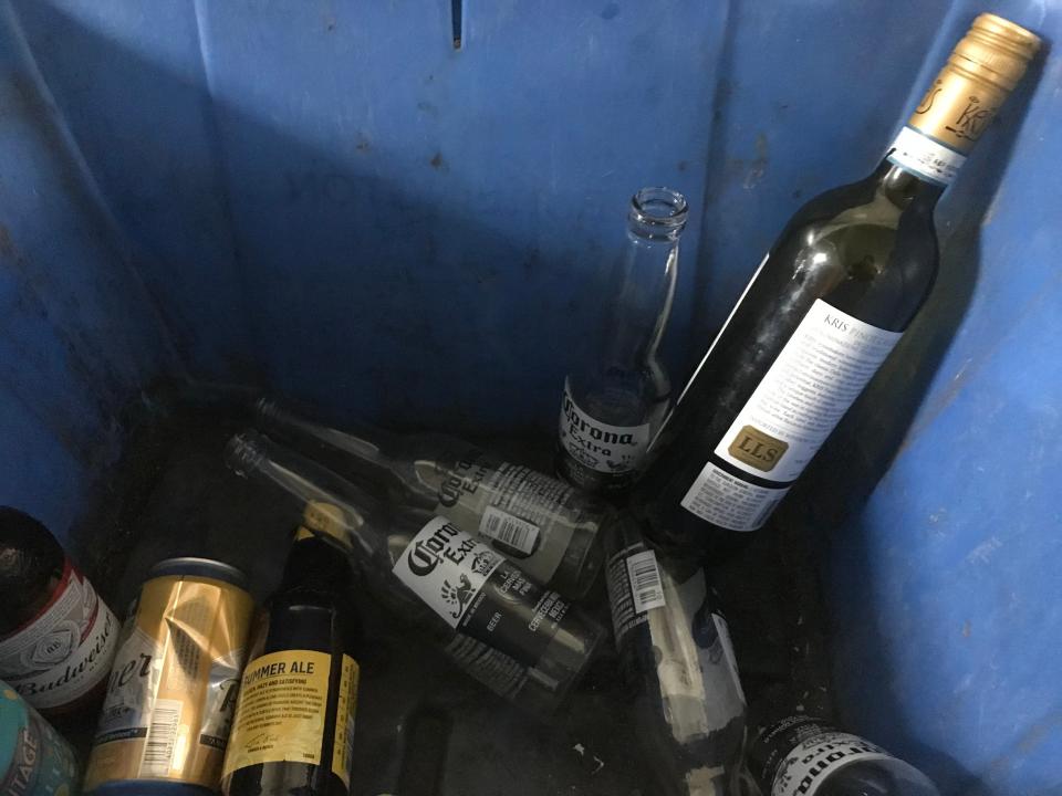 A capped wine bottle awaits recycling in a blue bin on South Winooski Avenue in Burlington on Monday, June 3, 2019.