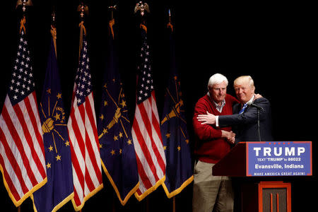 U.S. Republican presidential candidate Donald Trump is joined on stage by former Indiana University basketball coach Bob Knight at a campaign event at the Old National Events Plaza in Evansville, Indiana, U.S., April 28, 2016. REUTERS/Aaron P. Bernstein