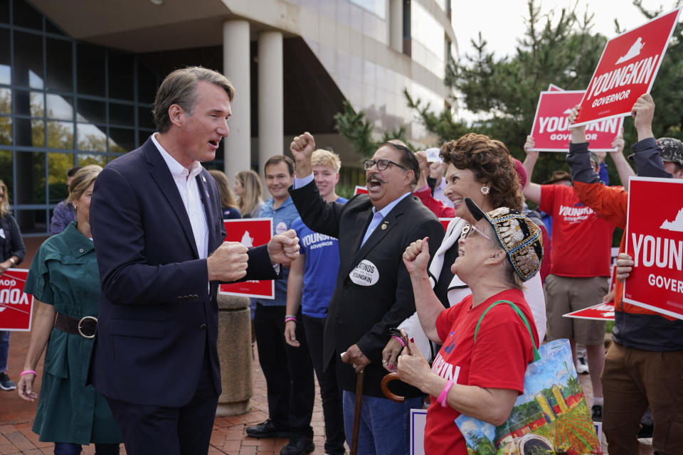 Virginia Republican gubernatorial candidate Glenn Youngkin and his wife Suzanne greet supporters after voting early, Thursday, Sept. 23, 2021, in Fairfax, Va. (AP Photo/Patrick Semansky)