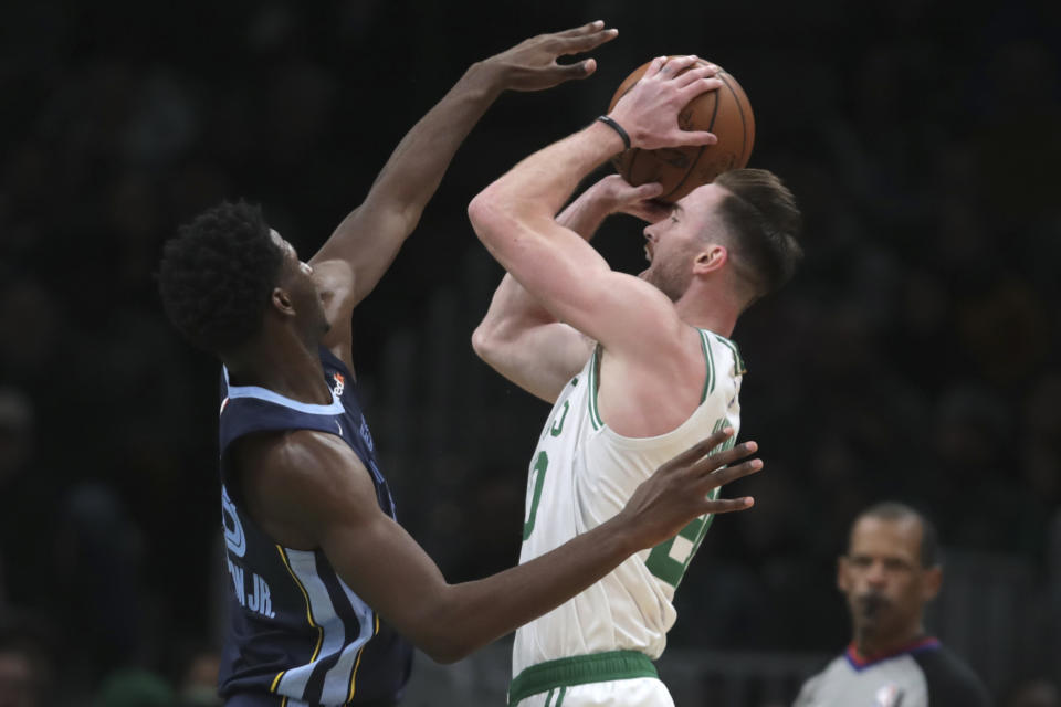 Memphis Grizzlies forward Jaren Jackson Jr., left, tries to block Boston Celtics forward Gordon Hayward during the first half of an NBA basketball game in Boston, Wednesday, Jan. 22, 2020. (AP Photo/Charles Krupa)