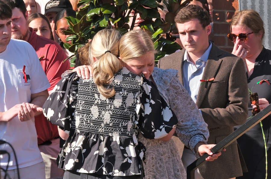 People gather at the Tate Plaza on the University of Georgia campus in Athens, Ga., Monday, Feb. 26, 2024, to pay tribute to Laken Riley, a nursing student at Augusta University’s Athens campus who was found dead Thursday, Feb. 22, after a roommate reported she didn’t return from a morning run in a wooded area of the UGA campus near its intramural fields. Panhellenic President Dabney Duncan hugs Alpha Chi Omega President Chloe Mullis after she spoke about what Riley meant to the sorority. People also gathered to pay tribute to a UGA student who committed suicide last week. (Nell Carroll/Atlanta Journal-Constitution via AP)