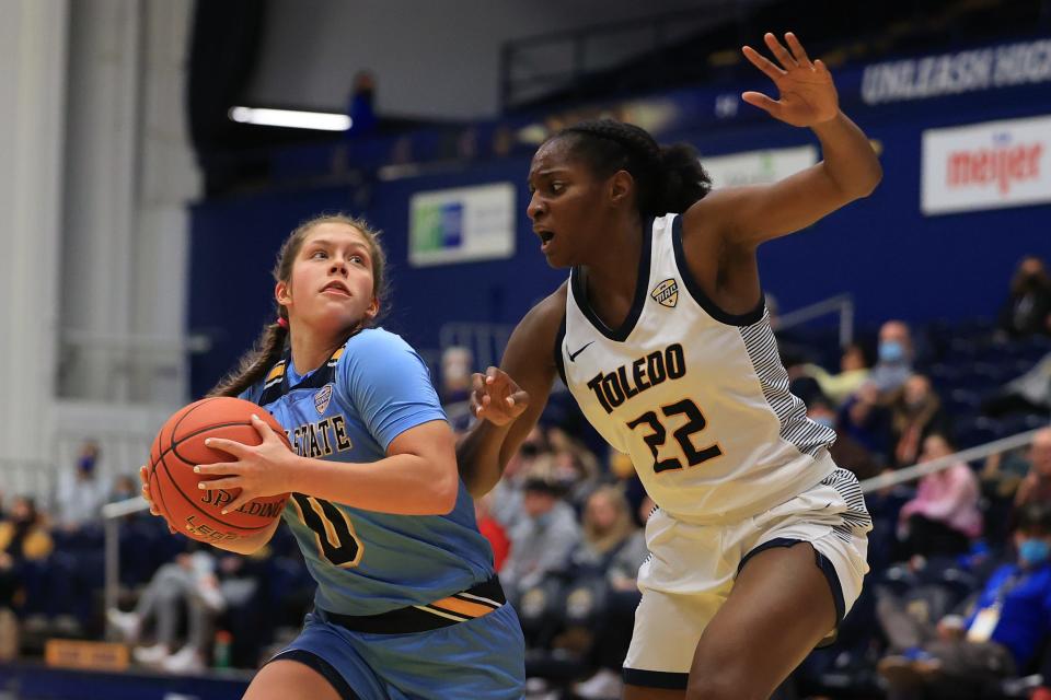 Kent State sophomore guard Casey Santoro drives past Toledo sophomore guard Khera Goss during Tuesday night's game against the Toledo Rockets at the M.A.C. Center in Kent, OH.