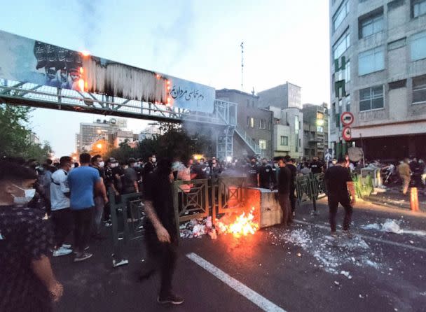 PHOTO: Iranian demonstrators burning a rubbish bin in the capital Tehran during a protest for Mahsa Amini, days after she died in police custody, in a photo obtained on Sept. 21, 2022. (AFP via Getty Images)