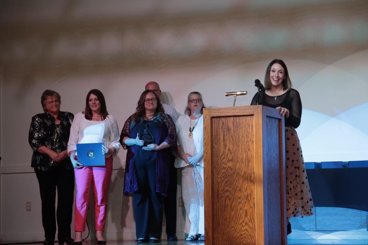 Amanda Gibson of Community Learning Connections in Tecumseh, along with several staff members, accepts the Making a Difference Award during the Greater Lenawee Chamber of Commerce's awards ceremony May 1 at the Adrian Armory Events Center.