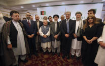 Afghan politicians and other participants pose for a photograph with Pakistani Foreign Minister Shah Mahmood Qureshi, fourth right, after the opening session of an Afghan Peace Conference in Bhurban, 65 kilometers (40 miles) north of Islamabad, Pakistan, Saturday, June 22, 2019. Dozens of Afghan political leaders attended a peace conference in neighboring Pakistan on Saturday to pave the way for further Afghan-to-Afghan dialogue. (AP Photo/Anjum Naveed)