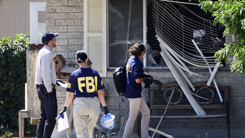 Law enforcement agents investigate at the home of Craig Deeleuw Robertson who was shot and killed by FBI agents in Provo on Wednesday, Aug. 9, 2023. Robertson posted threatening comments about President Joe Biden hours before the president was scheduled to visit Utah.