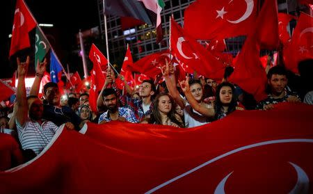 People shout slogans and wave Turkish national flags as they gather in solidarity night after night since the July 15 coup attempt in central Ankara, Turkey, July 27, 2016. REUTERS/Umit Bektas