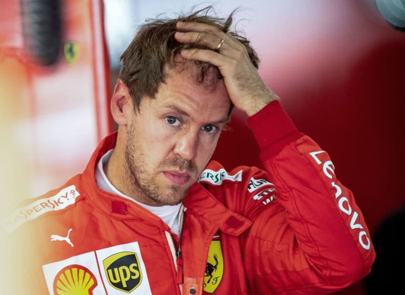 Sebastian Vettel of Germany's Scuderia Ferrari team stands in his pit box after the second free practice session during Formula 1 German Grand Prix. Vettel to test Porsche sportscar as comeback speculation mounts. Fabian Sommer/dpa