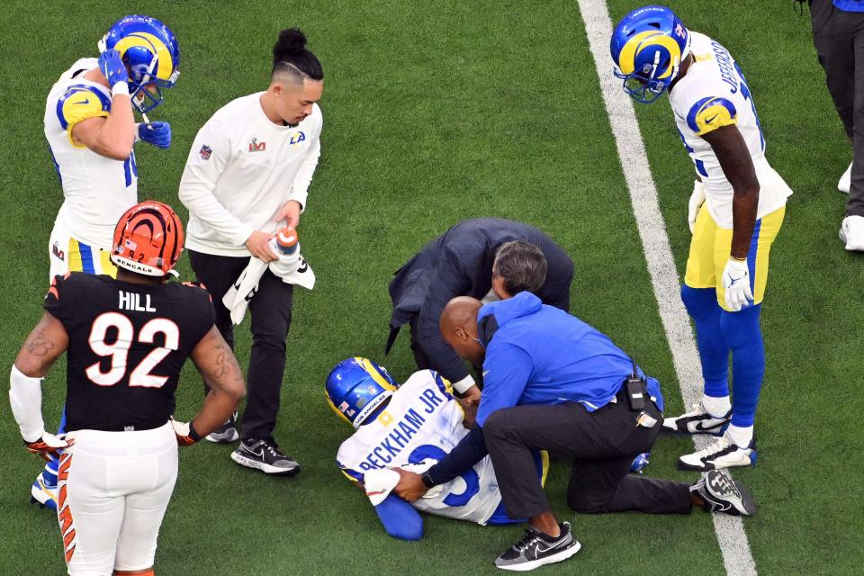 Los Angeles Rams staff attend to wide receiver Odell Beckham Jr. (3) after a play in the second quarter against the Cincinnati Bengals in Super Bowl LVI at SoFi Stadium.