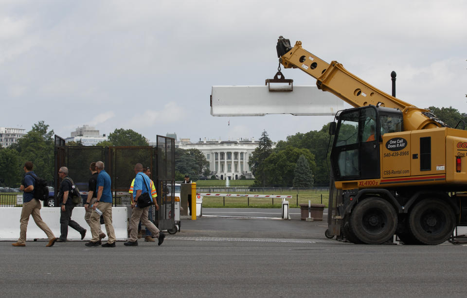 Concrete barricades that secure the interior base of the temporary perimeter fence surrounding the White House area are removed, Wednesday, June 10, 2020, in Washington. The fence was put up because of the protests that began over the death of George Floyd, a black man who was in police custody in Minneapolis. Floyd died after being restrained by Minneapolis police officers. (AP Photo/Carolyn Kaster)