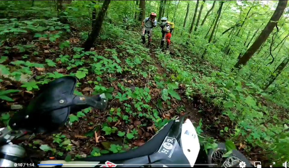 Zack Rosson and Mike Broetzmann stood at a safe distance after Troy Roberts crashed into a timber rattlesnake.