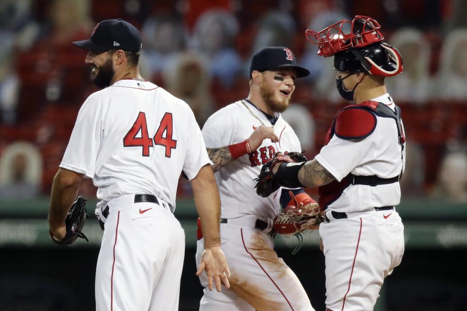 Boston Red Sox's Alex Verdugo, center, celebrates with Brandon Workman (44) and Christian Vazquez after the Red Sox defeated the Toronto Blue Jays during a baseball game, Friday, Aug. 7, 2020, in Boston. (AP Photo/Michael Dwyer)