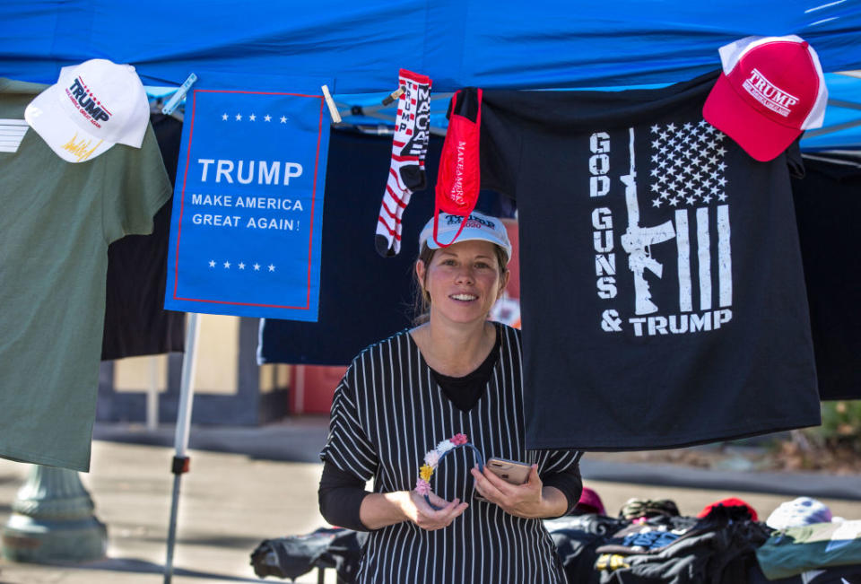 A woman sells Donald Trump hats and shirts at an election protest for Trump supporters on December 20. Source: Getty