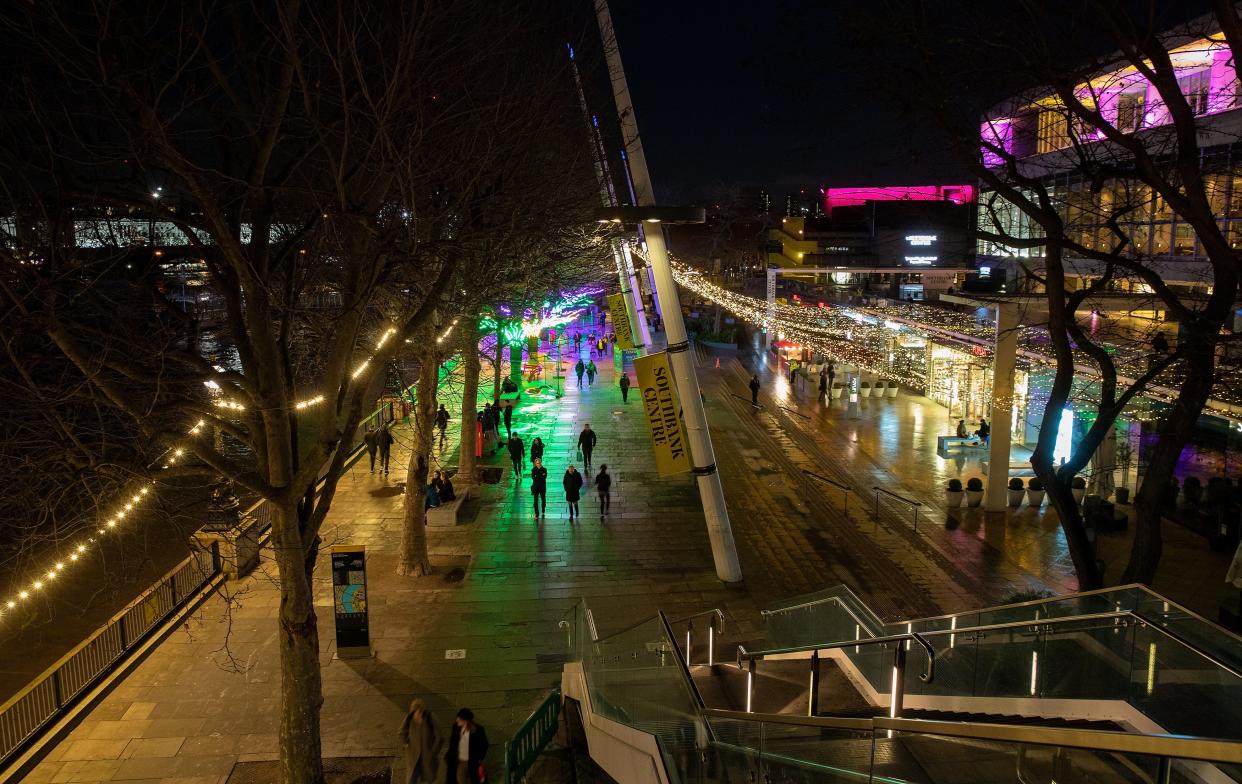 A view of people walking along Southbank lit with Christmas Lights during Tier 3 of the Covid-19 Pandemic Lockdown on 17 December 2020 in London. (Jo Hale/Getty Images)