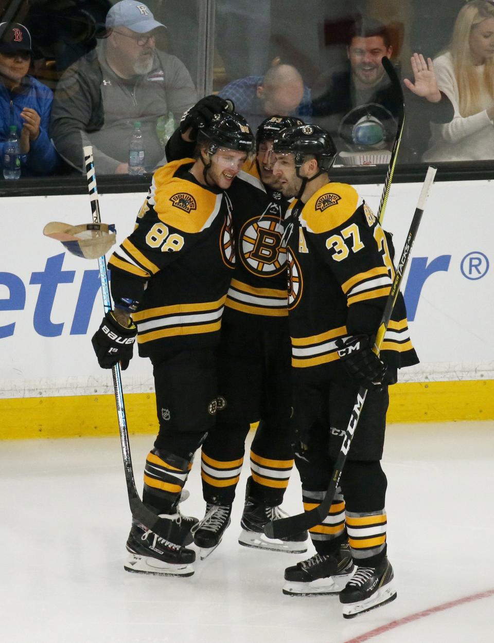 <p>
              A cap falls past Boston Bruins right wing David Pastrnak (88) as he celebrates his third goal of an NHL hockey game with teammates Brad Marchand, center, and Patrice Bergeron (37) during the third period against the Detroit Red Wings, Saturday, Oct. 13, 2018, in Boston. (AP Photo/Mary Schwalm)
            </p>