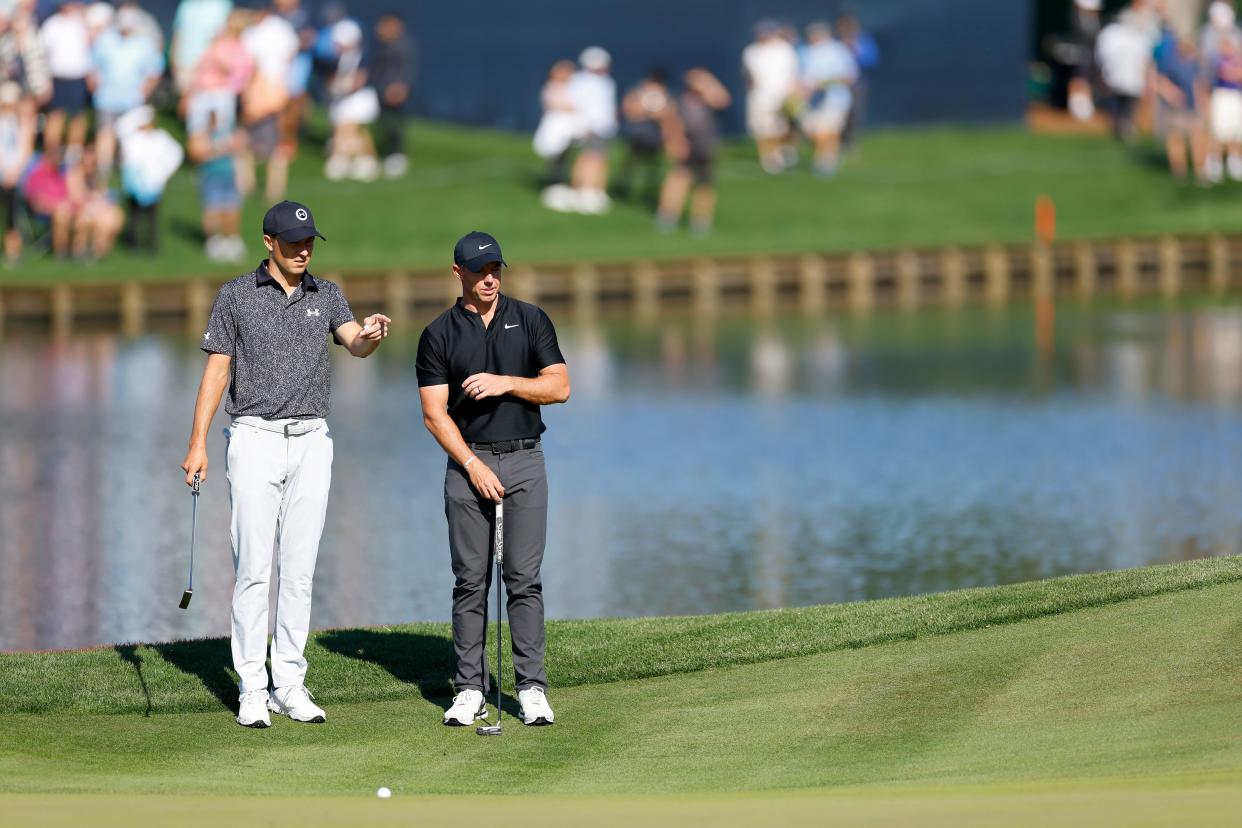 Jordan Spieth of the United States and Rory McIlroy of Northern Ireland look on from the 16th green during the first round of THE PLAYERS Championship on the Stadium Course at TPC Sawgrass on March 14, 2024 in Ponte Vedra Beach, Florida.