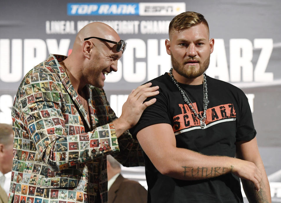 Boxers Tyson Fury (L) and Tom Schwarz pose during a news conference at MGM Grand Hotel & Casino on June 12, 2019 in Las Vegas, Nevada. The two will meet in a heavyweight bout on June 15 at MGM Grand Garden Arena in Las Vegas.  (Photo by Ethan Miller/Getty Images)
