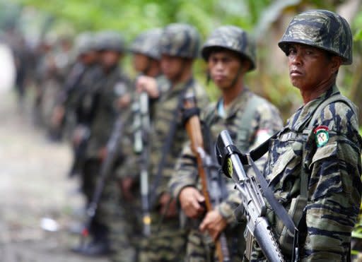 Moro Islamic Liberation Front (MILF) rebels stand guard as their chief Murad Ebrahim (not pictured) holds a press conference inside camp Darapanan, Sultan Kudarat town on October 27. Under the pact the 12,000-strong MILF would give up its quest for an independent homeland in the south in return for significant power and wealth-sharing in a new autonomous region there to be known as Bangsamoro