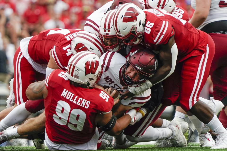 New Mexico State quarterback Diego Pavia is stopped during the first half of an NCAA college football game against the Wisconsin Saturday, Sept. 17, 2022, in Madison, Wis. (AP Photo/Morry Gash)