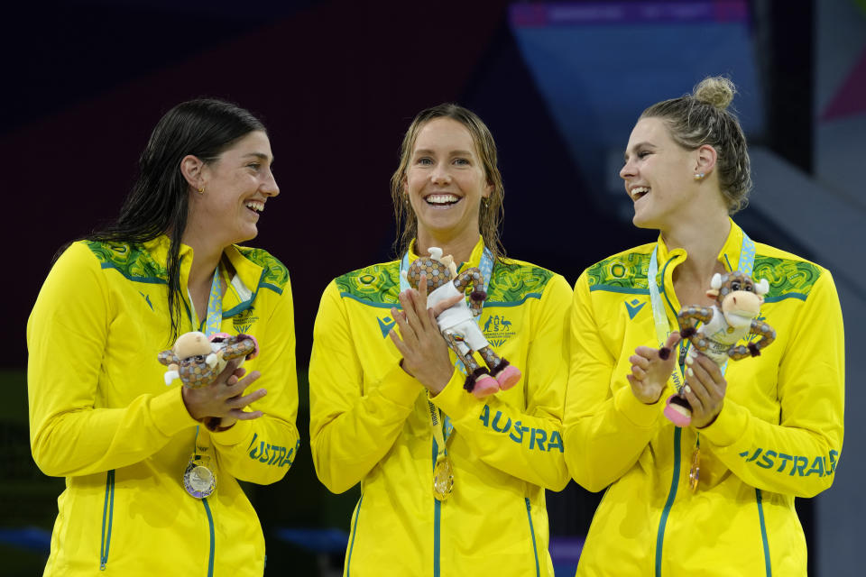 Australia's Emma McKeon, centre, gold with Australia's Meg Harris, silver, left and Australia's Shayna Jack, bronze stand on the podium during the medal ceremony for the Women's 50m Freestyle during the swimming at the Commonwealth Games in Sandwell Aquatics Centre in Birmingham, England, Sunday, July 31, 2022. (AP Photo/Kirsty Wigglesworth)