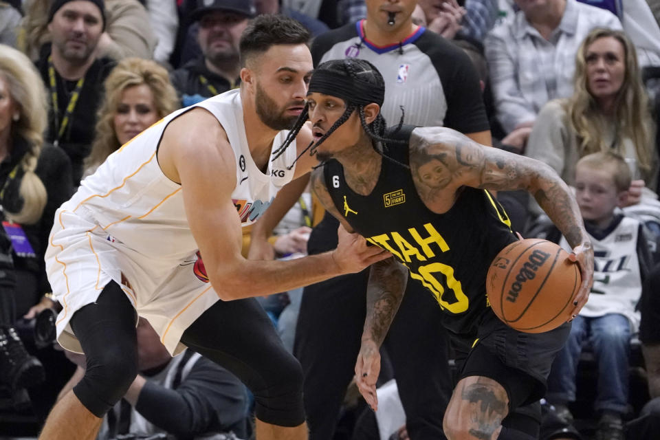Utah Jazz guard Jordan Clarkson (00) is defended by Miami Heat guard Max Strus during the first half of an NBA basketball game Saturday, Dec. 31, 2022, in Salt Lake City. (AP Photo/George Frey)