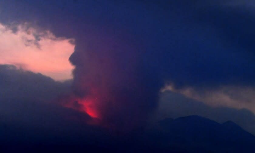 This long exposure image shows the eruption of volcano Sakurajima Sunday night, July 24, 2022, in the view from Tarumizu city, Japan's southern prefecture of Kagoshima. Japan's Meteorological Agency said a volcano on Japan's southern main island of Kyushu erupted Sunday night, spewing ash and volcanic rocks, but there were no immediate reports of damage or injuries in nearby towns. (Kyodo News via AP)