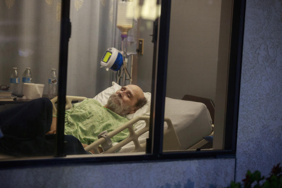 PORTERVILLE, UNITED STATES - APRIL 27, 2020: Jerry Hogan, a Vietnam Veteran, lies on a bed at Lindsey Gardens after testing positive for COVID-19/Coronavirus, a week earlier Hogan had been in the hospital, where he had pneumonia unrelated to Coronavirus, and had tested negative, when he was sent to a skilled nursing facility for rehabilitation, then there was an outbreak at the facility where he then tested positive a few days later.- PHOTOGRAPH BY Jeremy Hogan / Echoes Wire/ Barcroft Studios / Future Publishing (Photo credit should read Jeremy Hogan / Echoes Wire/Barcroft Media via Getty Images)