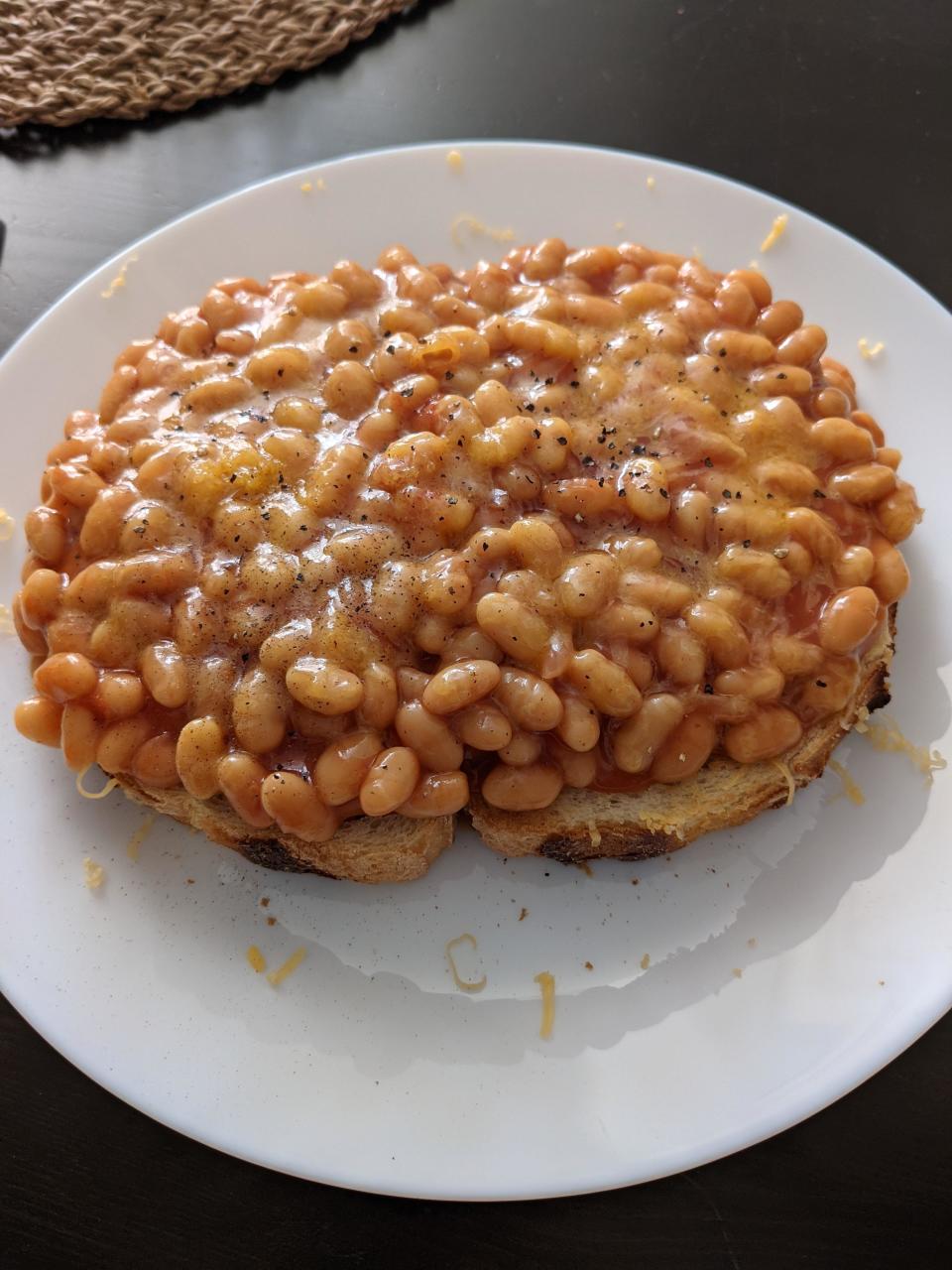 baked beans and shredded cheese on top a piece of toast