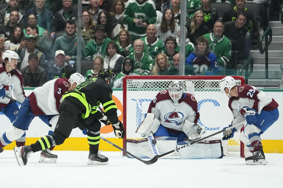 Colorado Avalanche goaltender Alexandar Georgiev, second from right, blocks a shot by Dallas Stars left wing Jamie Benn, third from left, during the second period of an NHL hockey game, Saturday, Nov. 18, 2023, in Dallas. (AP Photo/Julio Cortez)