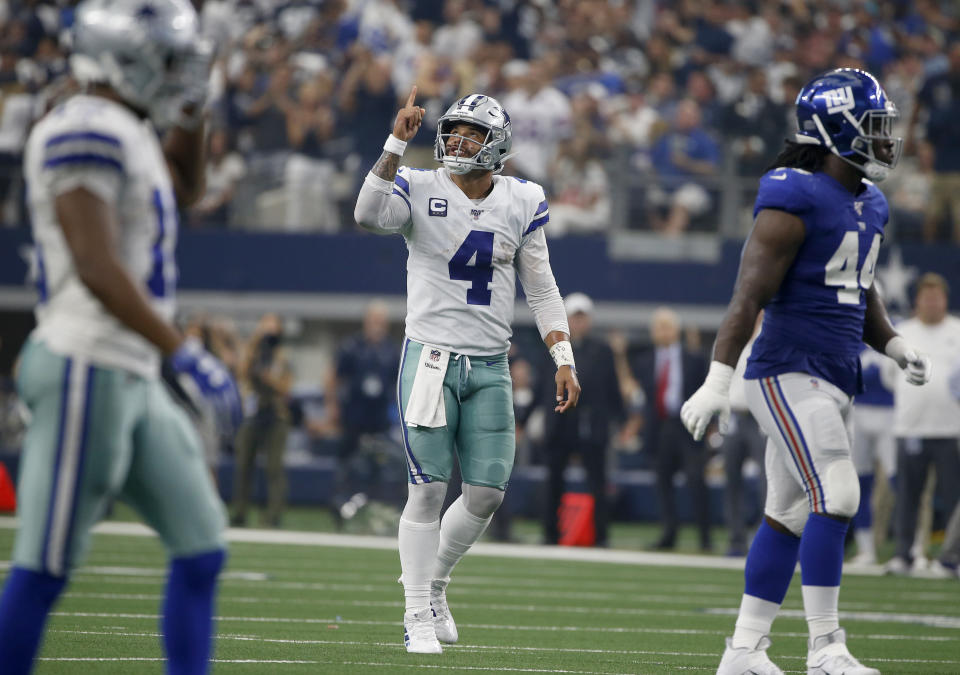 Dallas Cowboys' Dak Prescott (4) celebrates a touchdown as New York Giants linebacker Markus Golden (44) walks away in the first half of a NFL football game in Arlington, Texas, Sunday, Sept. 8, 2019. (AP Photo/Ron Jenkins)