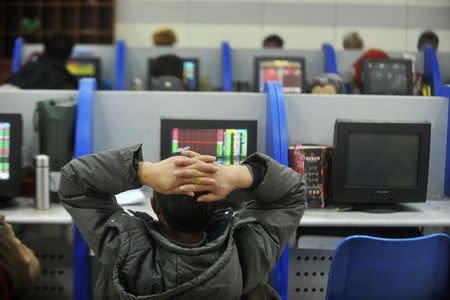 An investor looks at an computer screen showing stock information at a brokerage house in Yangzhou, Jiangsu province, China, January 5, 2016. REUTERS/Stringer