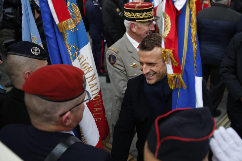 French President Emmanuel Macron with French Armies Chief of Staff General Francois Lecointre, behind, meets veterans under the Arc de Triomphe during commemorations marking the 101st anniversary of the 1918 armistice, ending World War I, Monday Nov. 11, 2019 in Paris (AP Photo/Francois Mori, Pool)