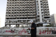 A man walks by a destroyed building after a massive explosion in Beirut, Lebanon, Wednesday, Aug. 5, 2020. (AP Photo/Hassan Ammar)