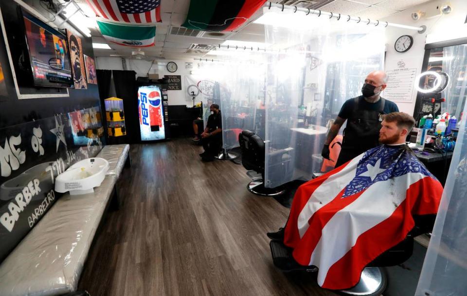 Jesse Padilla, owner of The Right Cut Barber Shop in Cary, N.C., and customer Andrew Bardsley watch as the verdict is read in the trial of Derek Chauvin Tuesday, April 20, 2021. Padilla said he was happy to see the verdict and see Chauvin be held accountable. “It is not the end but a step in the right direction” said Padilla.