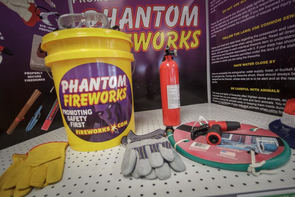 Ira Schwartz, regional manager for Phantom Fireworks, has a display of recommended safety gear for firework use at the Forest Hill Boulevard store in Palm Springs, Fla., on Monday, June 29, 2020.