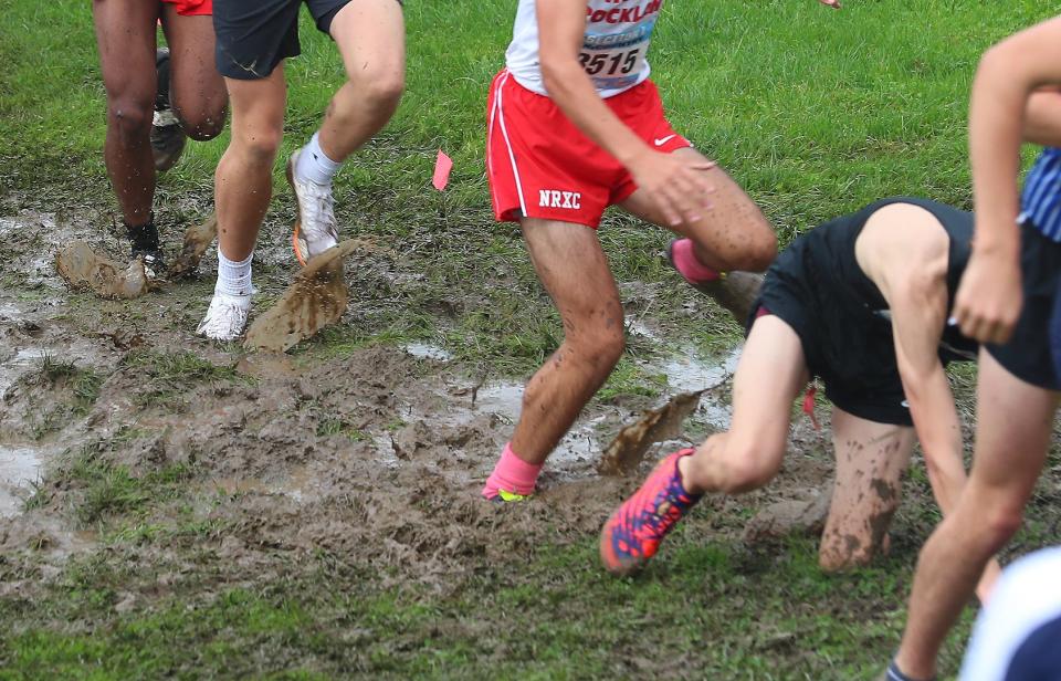 Runners in the Boys Varsity II race navigate the mud during the Section 1 Coaches Cross-Country Invitational at Bowdoin Park in Wappingers Falls Oct. 21, 2023.