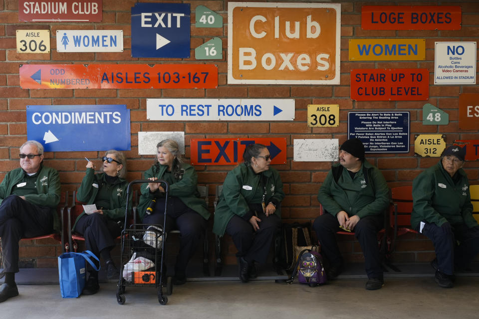 Employees wait for the start of a baseball game between the Los Angeles Dodgers and the St. Louis Cardinals Thursday, March 28, 2024, in Los Angeles. (AP Photo/Jae C. Hong)