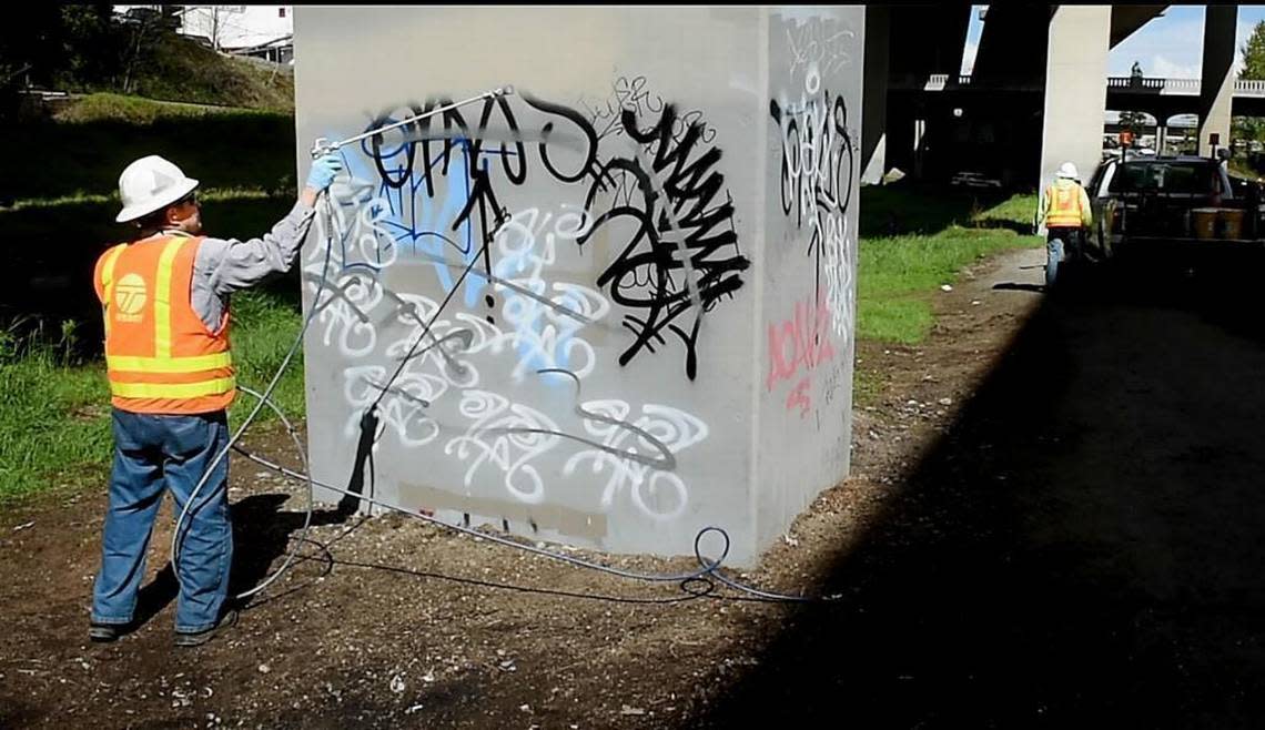 DOT worker John Spading paints over graffiti sprayed on a bridge pier underneath I-705 in Tacoma in 2017. Phase 2 of the city’s crime plan calls reducing visible disorder associated with crime, like graffiti and open drug use. Drew Perine/dperine@thenewstribune.com