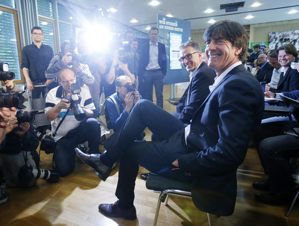 Joachim Loew, the coach of German national soccer team, smiles as he waits for the beginning of a press conference where he presented his preliminary team for the upcoming World Cup in Brazil in Frankfurt, Germany, Thursday, May 8, 2014. (AP Photo/Michael Probst)
